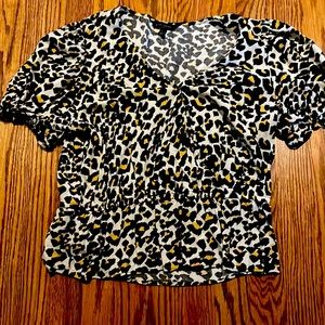 Cropped peplum style top with puffy sleeve.